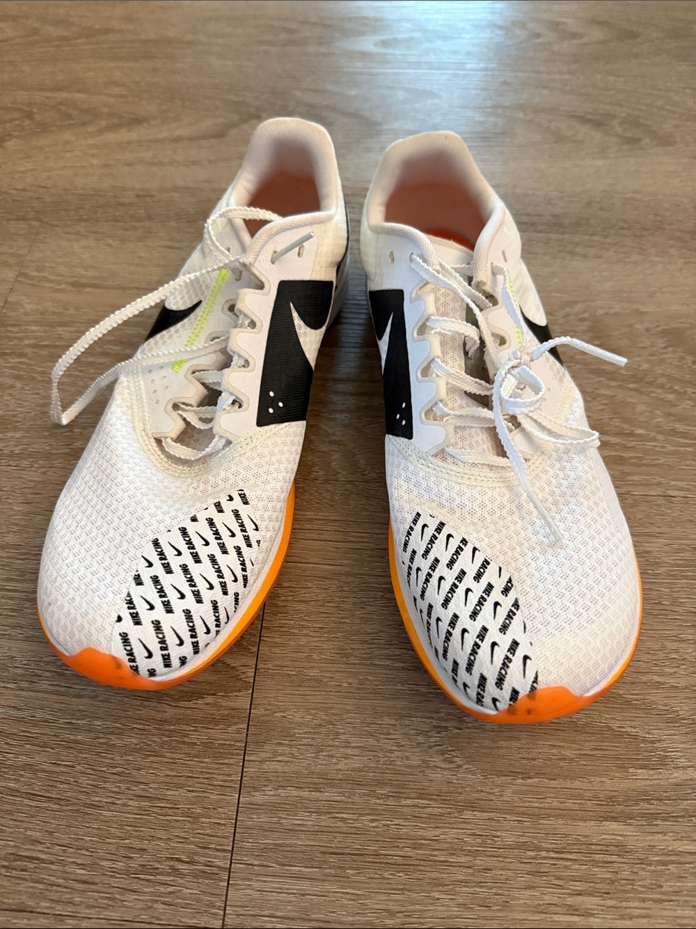Nike White Running Shoes with Black Swoosh and Orange Accents